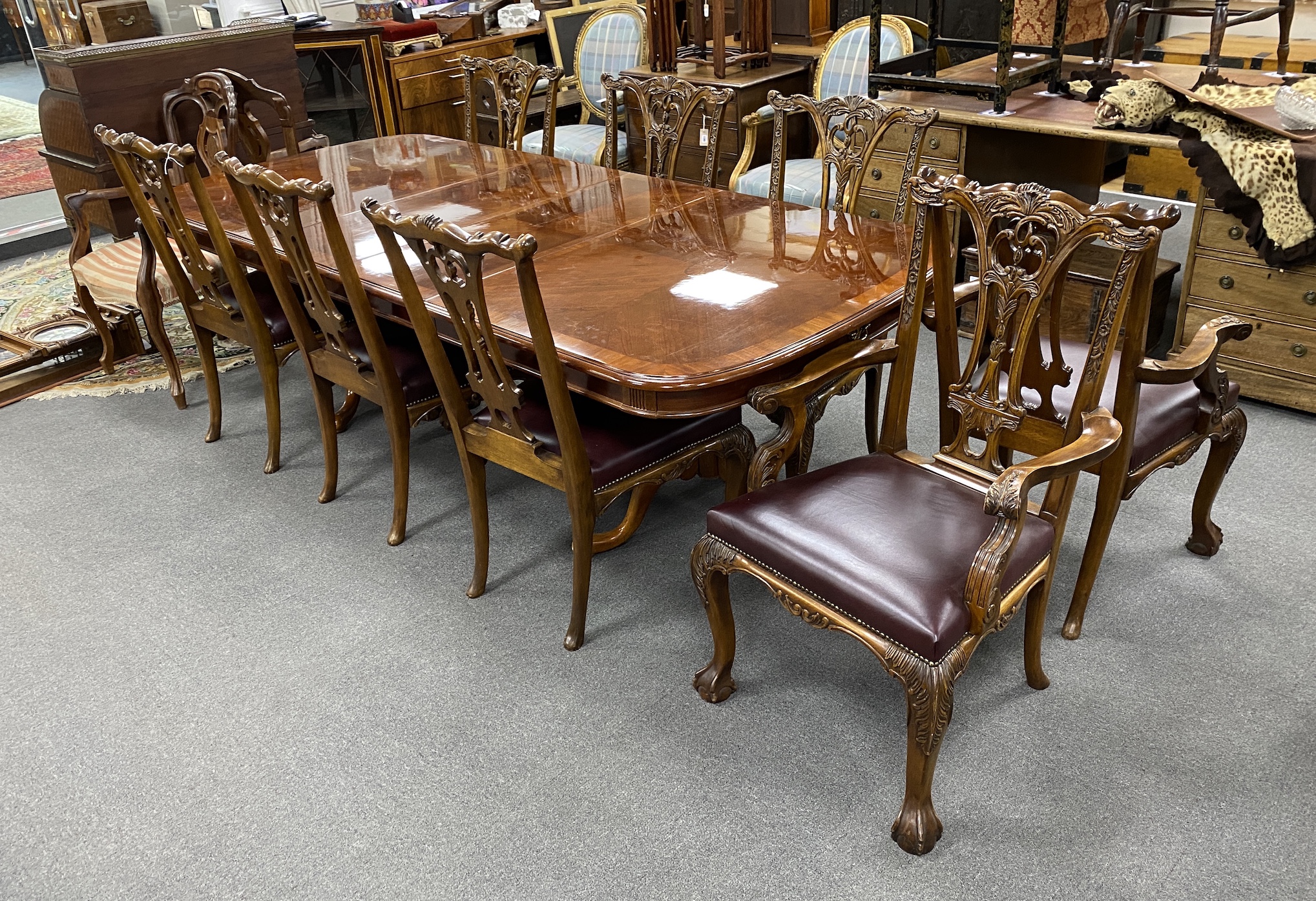 A reproduction inlaid mahogany twin pillar extending dining table, approx. 250cm extended, two spare leaves, width 110cm, height 75cm, together with eight Chippendale style mahogany dining chairs, two with arms